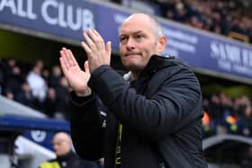 Alex Neil, manager of Millwall, claps the fans at The Den.