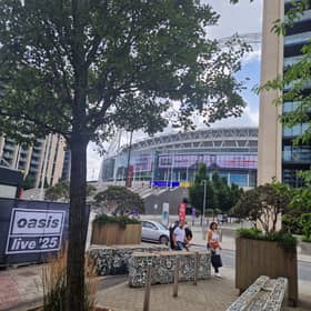 A man has died after falling from the upper tier during an Oasis gig at Wembley Stadium.