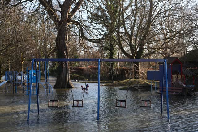 Floodwater surrounds swings and play equipment in a flooded children's park in Wraysbury, west of London on January 9, 2024