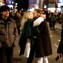 A couple smooch in Soho after leaving a bar