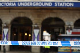 A police cordon is displayed outside Victoria Underground station near the site of a bus crash