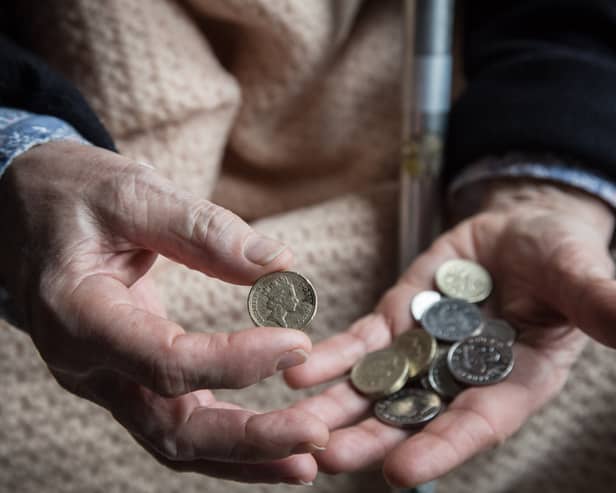 An elderly person looks at cash at home. Winter Fuel Payments for 2025/26 will start arriving in November, with most paid by December (Photo: Matt Cardy/Getty Images)
