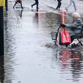 Pensioner using a mobility scooter crosses the Euston Puddle