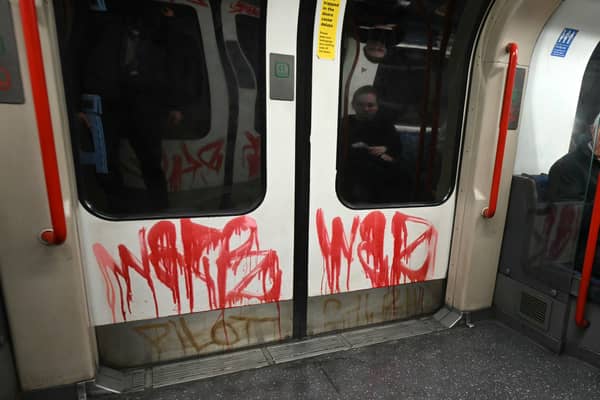 Graffiti is pictured, dawbed on the doors on a Central Line underground train in London