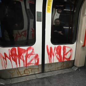 Graffiti is pictured, dawbed on the doors on a Central Line underground train in London