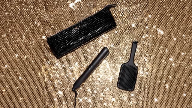 Black ghd Gold hair straightener gift set with paddle brush and heat-resistant bag