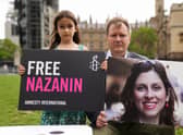 File photo dated 23/09/21 of Richard Ratcliffe and his daughter Gabriella holding signs in Parliament Square, London, to mark the 2,000th day Nazanin Zaghari-Ratcliffe had been detained in Iran.