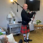 Bagpiper Bob Adam plays the bagpipes
