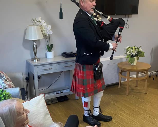 Bagpiper Bob Adam plays the bagpipes