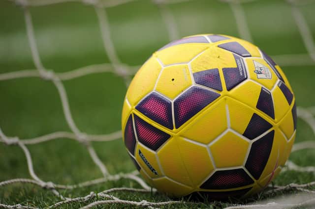 File photo dated 28/2/2015 of a ball in the net. Premier League football clubs are being urged to end "poverty pay" among staff including cleaners and security guards amid record player signings ahead of the new season.