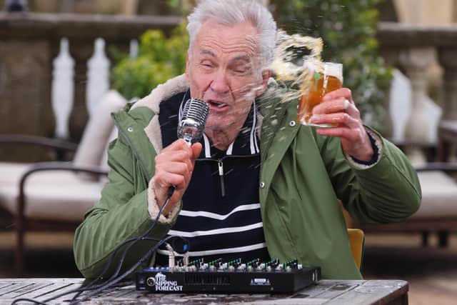 Larry Lamb battling the wind, delivering The Sipping Forecast to help the country navigate unpredictable pub-garden weather this spring.