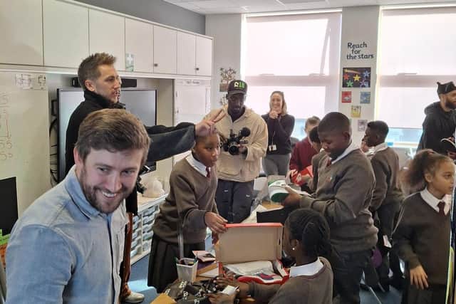 Miniminter watching on as Chestnut Park Primary School students open their gifts