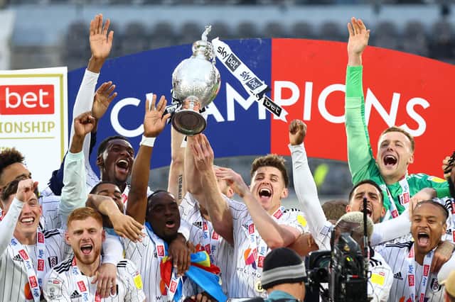 Tom Cairney of Fulham lifts the Sky Bet Championship Trophy.