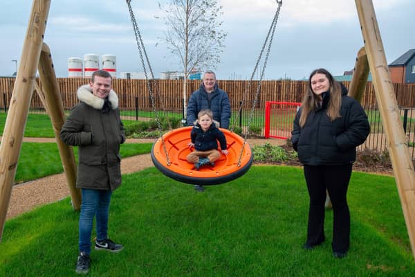 Finley Hammond-Smith enjoys a ride in one of the swings at the newly opened play area at Bellway’s Oxenden Park development in Herne Bay. Also pictured are, from left: Benjamin Smith; Justin Smith; and Bonnie Smith.