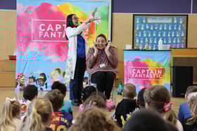 Children from Coteford Infant School enjoy a performance from Captain Fantastic