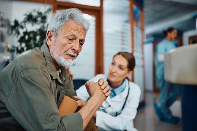 Man comforted by doctor