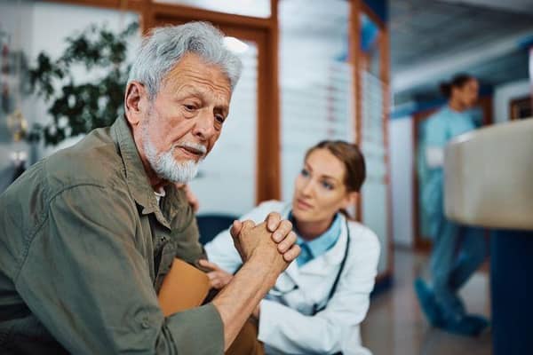 Man comforted by doctor