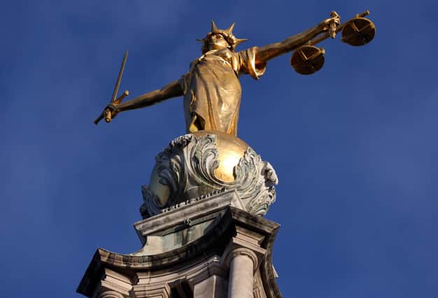 FW Pomeroy's Statue of Justice stands atop the Central Criminal Court building, Old Bailey, London.