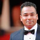 Krishnan Guru-Murthy has apologised “unreservedly” to Northern Ireland minister Steve Baker after swearing at him in an “unguarded moment”.