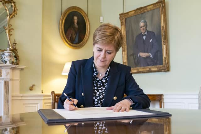 Nicola Sturgeon signs her official letter of resignation as First Minister to King Charles III (Picture: Jane Barlow/PA)