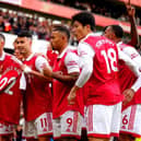 Arsenal's Gabriel Martinelli (centre) holds up former team-mate Pablo Mari's shirt as he celebrates scoring their side's first goal of the game during the Premier League match at the Emirates Stadium,