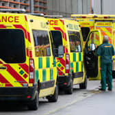 A paramedic walks past a line of ambulances outside the Royal London Hospital, in London. Picture date: Monday December 27, 2021.