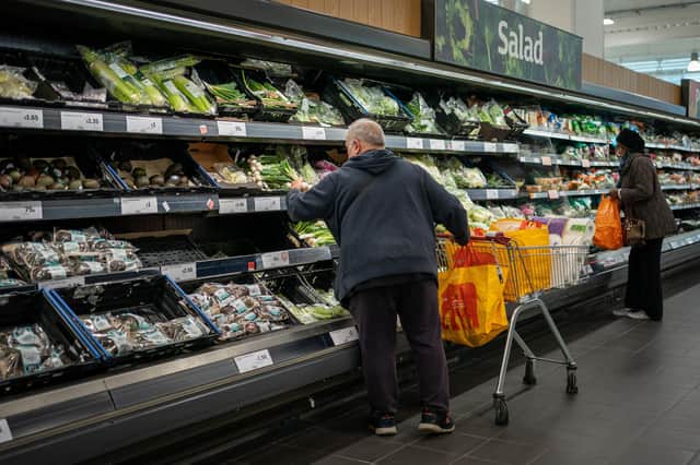Shoppers in the fruit and vegetables section of a branch of Sainsbury's in south London. Shoppers are said to be buying a raft of Christmas items, such as presents and frozen turkeys, early in a bid to make sure their festive celebrations are not heavily disrupted for a second year. Picture date: Friday October 15, 2021.