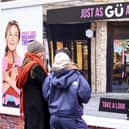 A member of the public interacts with an activation in Borough Yards by Gü to celebrate the launch of Bridget Jones: Mad About the Boy. This Valentine’s week, Gü has unveiled the UK’s first complimenting billboard. The interactive activation serves uplifting compliments inspired by beloved characters from the Bridget Jones franchise. Visitors can also enjoy full sized products from Gü’s signature range. A recent study, conducted by Gü, found that two thirds agreed that receiving a genuine compliment can turn their week around (68%) – not just their day. Photo credit: Gü and Ollie Dixon