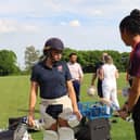 Sophia Dunkley testing a student's bat