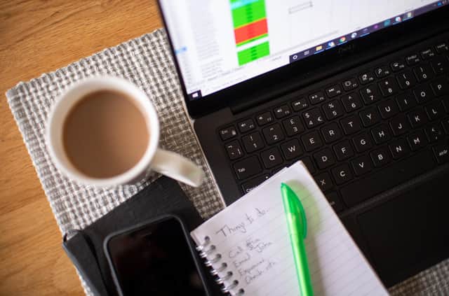 Stock photo of a laptop on a dining room table set up as a remote office to work from home. Workers told to self-isolate due to coronavirus will receive sick pay from day one, the Prime Minister has announced, as England's Chief Medical Officer warned that a UK epidemic is now "likely".