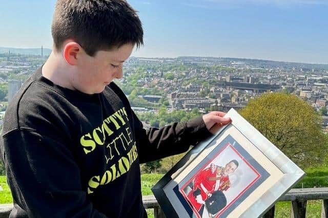 Jack with a photo of his dad Lee Rigby