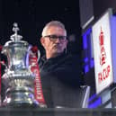 Gary Lineker sits in the BBC Studio next to the FA Cup
