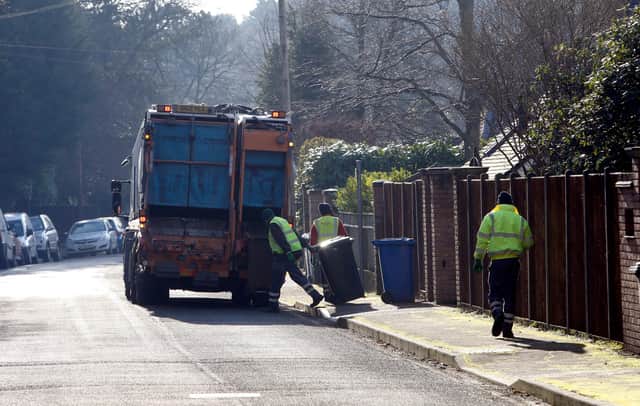 Council workers empty bins in Sunningdale, Berkshire .