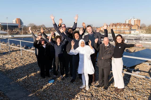 Members of Community Energy Newham celebrate their solar share offer on the roof of Stratford's library