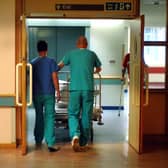 Orderlies push a bed at the Royal Orthopaedic Hospital, Oswestry.