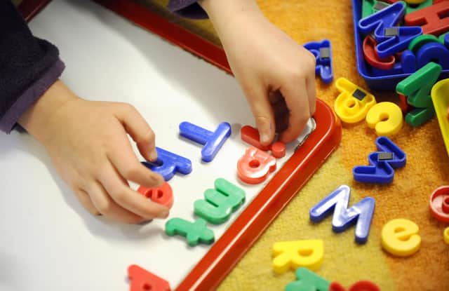 File photo dated 08/02/12 of a child playing, as parents can go online to find out what childcare they are eligible for under plans which will see nurseries expanded to provide more places and funding given to councils for wraparound care.