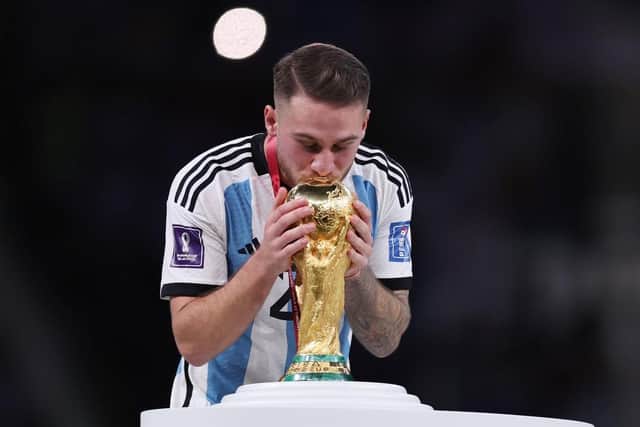 Alexis Mac Allister of Argentina kisses the FIFA World Cup Qatar 2022 Winner's Trophy during the FIFA World Cup Qatar 2022 Final match between Argentina and France at Lusail Stadium on December 18, 2022 in Lusail City, Qatar. (Photo by Clive Brunskill/Getty Images)