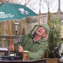 Larry Lamb battling the rain, delivering The Sipping Forecast to help the country navigate unpredictable pub-garden weather this spring.