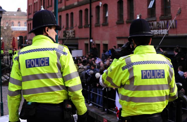Police watch the English Defence League protesters on the waterfront in Nottingham.