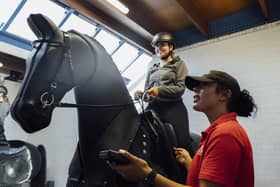 Rider with an instructor on the Equestrian Simulator at Lee Valley Riding Centre