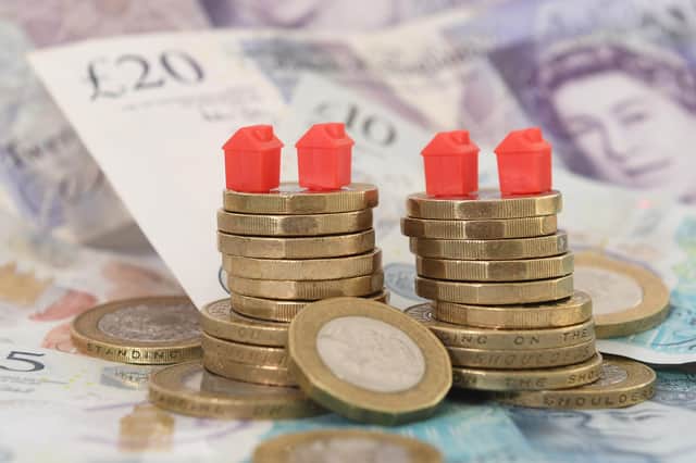 File photo dated 12/09/2018 of model houses on a pile of coins and bank notes. An extra 356,000 mortgage borrowers could face payment difficulties by the end of June 2024, in addition to those who are already behind, according to the City regulator. Issue date: Friday March 10, 2023.