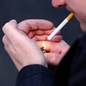 PICTURE POSED MY MODEL: A general view of a man smoking a cigarette.