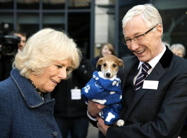 File photo dated 12/12/12  the Queen Consort, then the Duchess of Cornwall, with television presenter Paul O'Grady during her visit to Battersea Dogs & Cats Home in London.