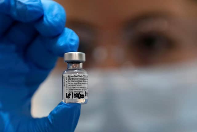 A nurse holds a phial of the Pfizer-BioNTech COVID-19 vaccine: Frank Augstein - Pool / Getty Images