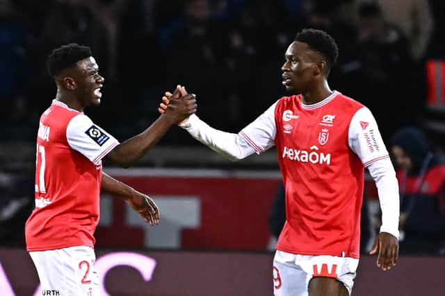 Reims' English forward Folarin Balogun (R) celebrates with Reims' Dutch midfielder Azor Matusiwa after scoring his team's first goal during the French L1 football match between Paris Saint-Germain (PSG) and Stade de Reims at the Parc des Princes stadium in Paris on January 29, 2023. (Photo by ANNE-CHRISTINE POUJOULAT/AFP via Getty Images)