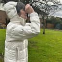 Resident Elaine Pieter looking at parakites through binoculars