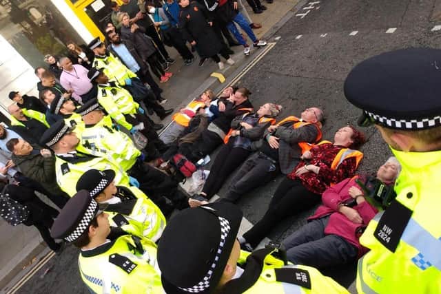 Just Stop Oil supporters lying on the ground during London road blockades.