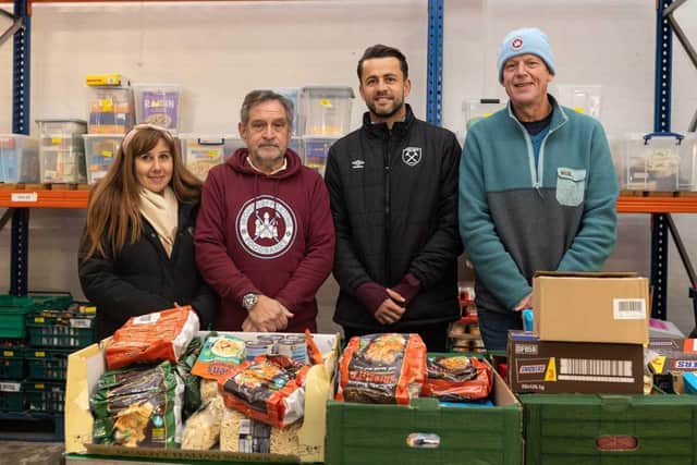 West Ham's Łukasz Fabiański alongside Irons Supporting Foodbanks at Community Food Enterprise, a Newham-based charity, to sort through a £2,000 pallet of food that had been donated by Hammers fans on matchdays.