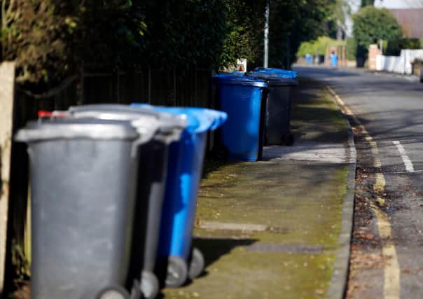 Rubbish (black) and recycling bins line a street in Sunningdale, Berkshire.