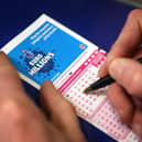 Filling out a lottery ticket.